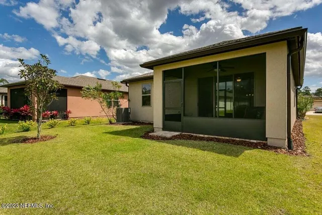 a view of a house with swimming pool and sitting area