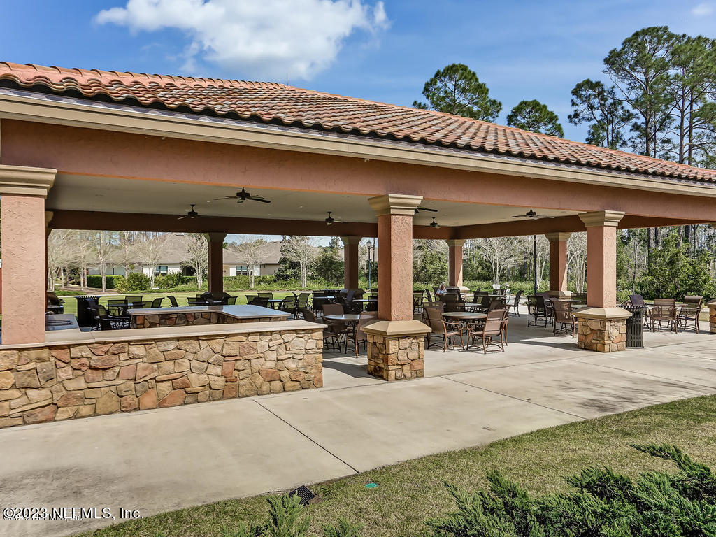 265 Caspia Lane Ponte Vedra, FL 32081 - Photo 54 of 86 a view of a patio with furniture and floor to ceiling window