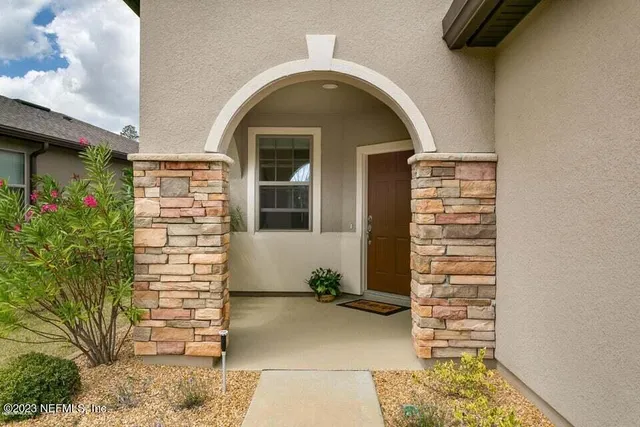 a view of a hallway with bathroom and front door