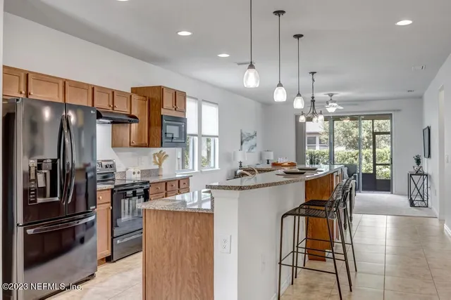 a kitchen with stainless steel appliances granite countertop a sink stove and microwave