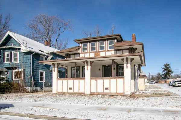 a front view of a house with a garden