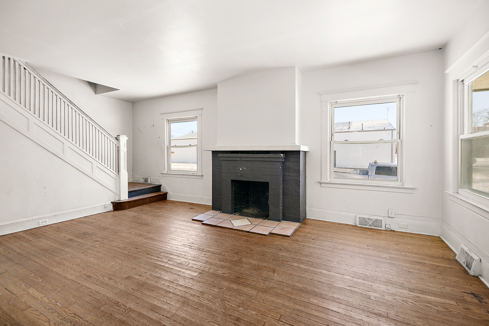 1295 East Merchant Street Kankakee, IL 60901 - Photo 12 of 17 a view of an empty room with wooden floor fireplace and a window