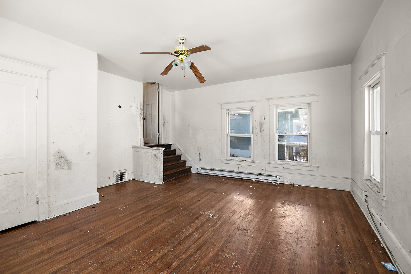 1295 East Merchant Street Kankakee, IL 60901 - Photo 13 of 17 a view of empty room with wooden floor and fan