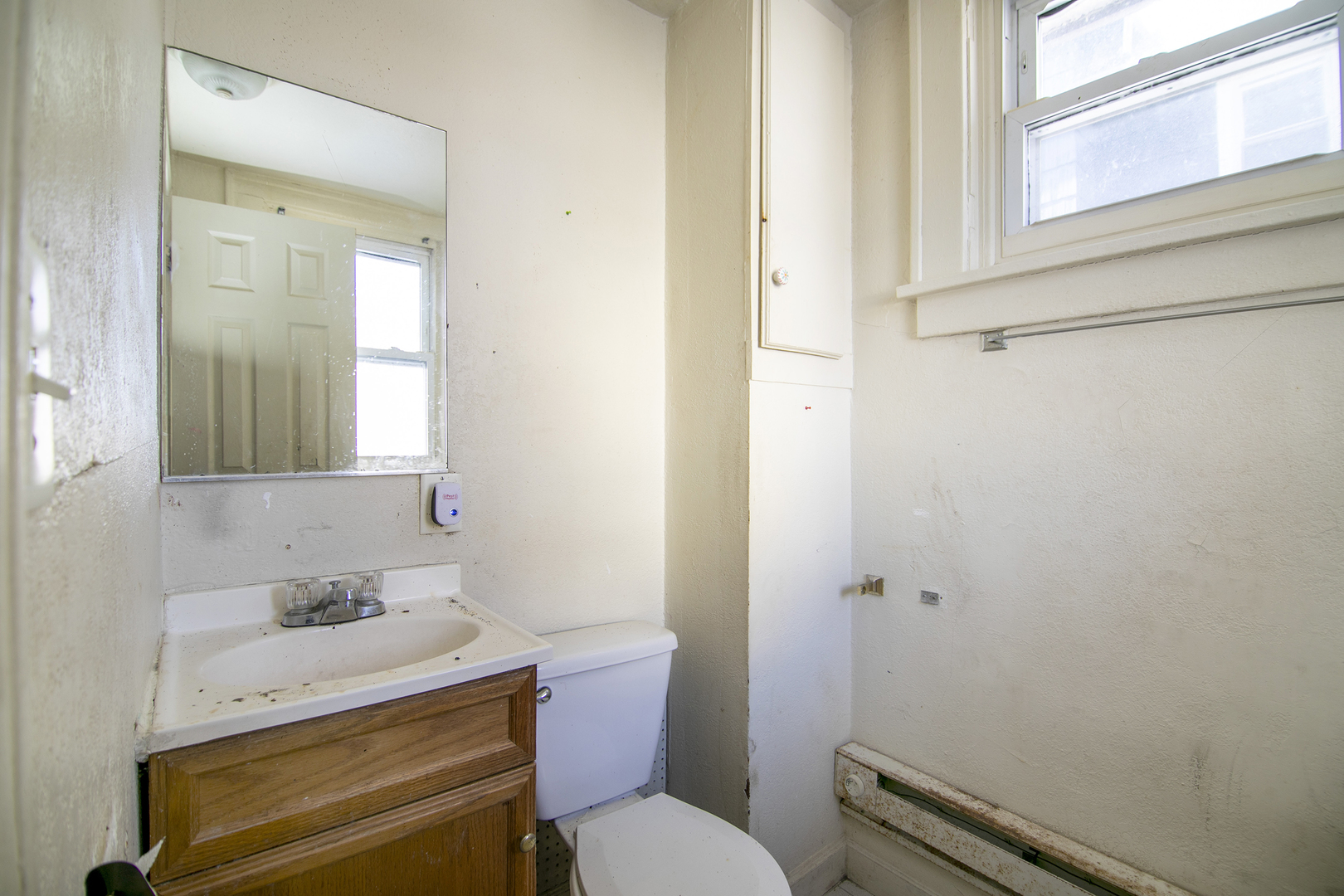 1295 East Merchant Street Kankakee, IL 60901 - Photo 15 of 17 a bathroom with a sink toilet and vanity