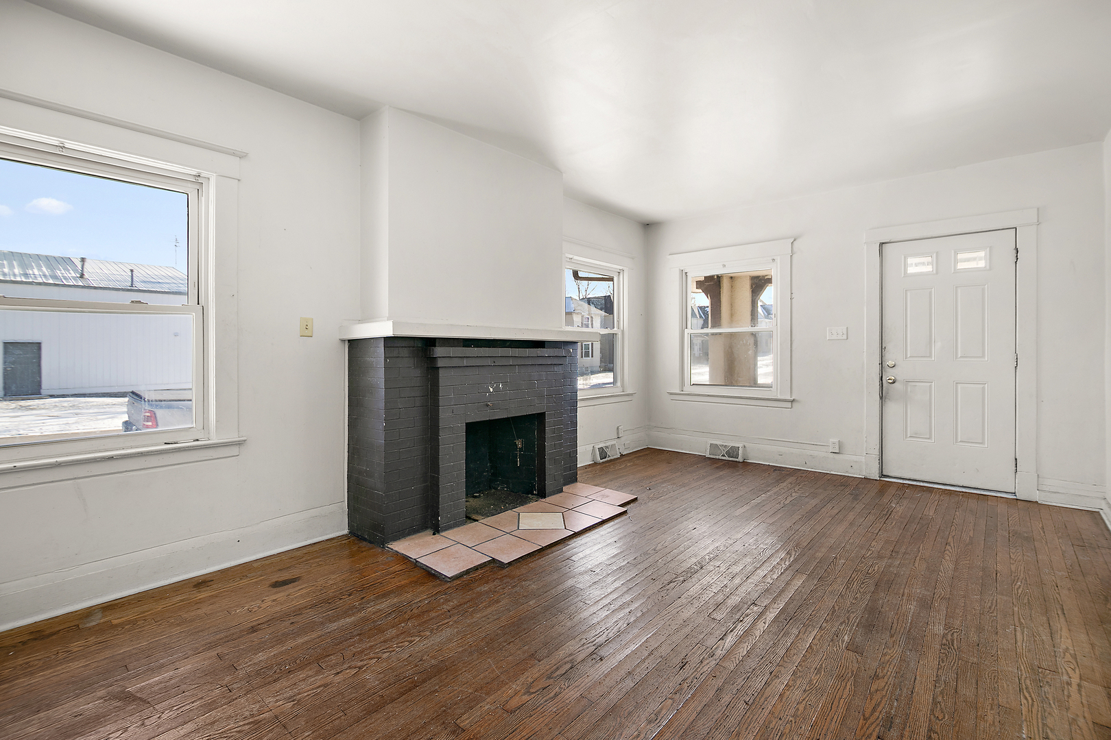 1295 East Merchant Street Kankakee, IL 60901 - Photo 17 of 17 wooden floor fireplace and windows in an empty room