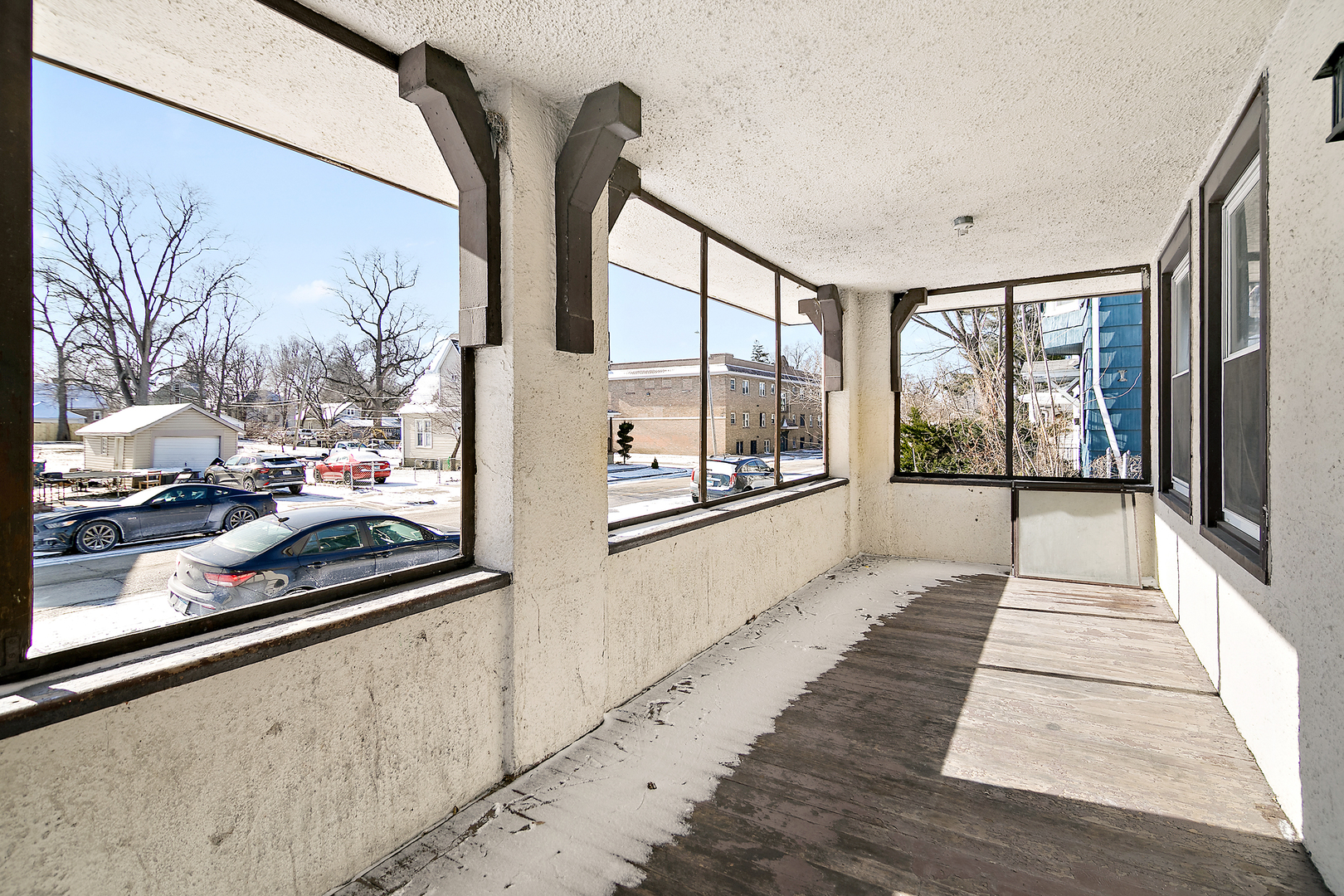 1295 East Merchant Street Kankakee, IL 60901 - Photo 4 of 17 a view of a balcony with wooden floor and iron stairs