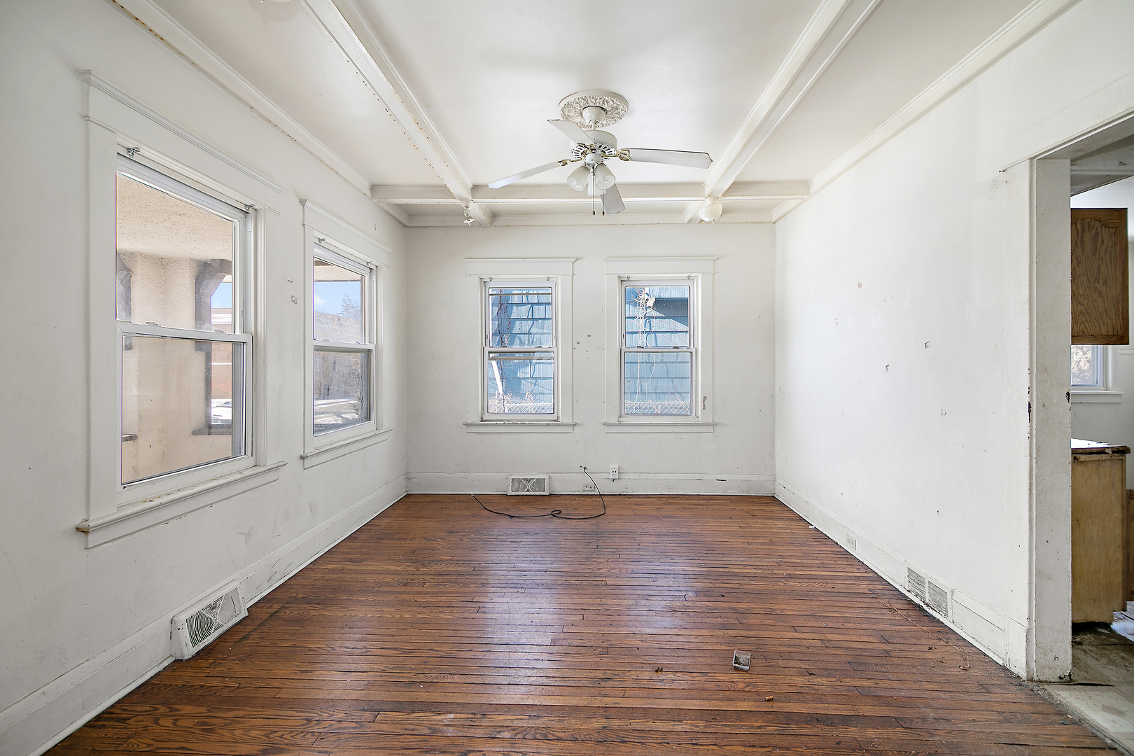 1295 East Merchant Street Kankakee, IL 60901 - Photo 7 of 17 a view of an empty room with wooden floor and a window