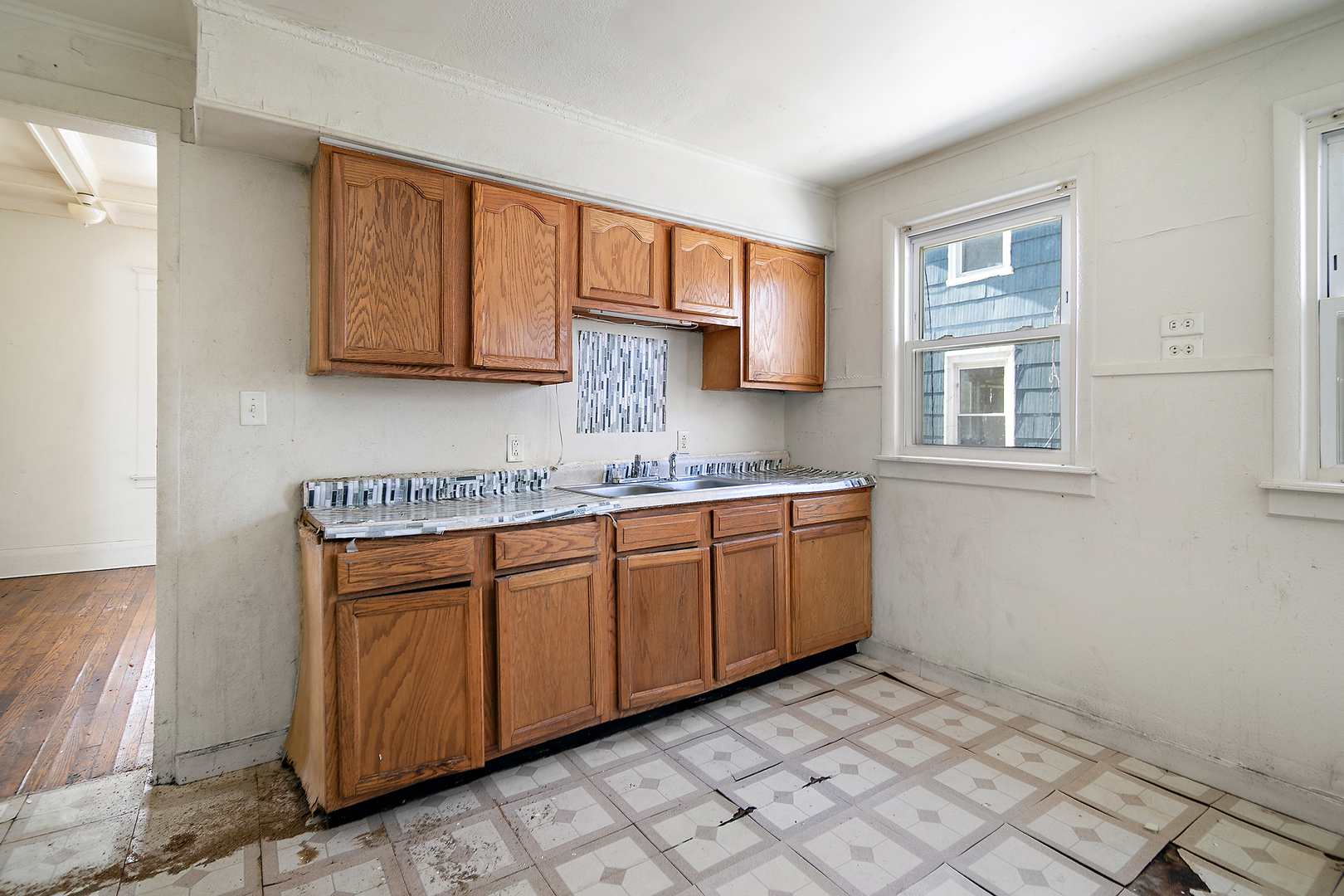 1295 East Merchant Street Kankakee, IL 60901 - Photo 10 of 17 a kitchen with stainless steel appliances granite countertop a sink stove and cabinets