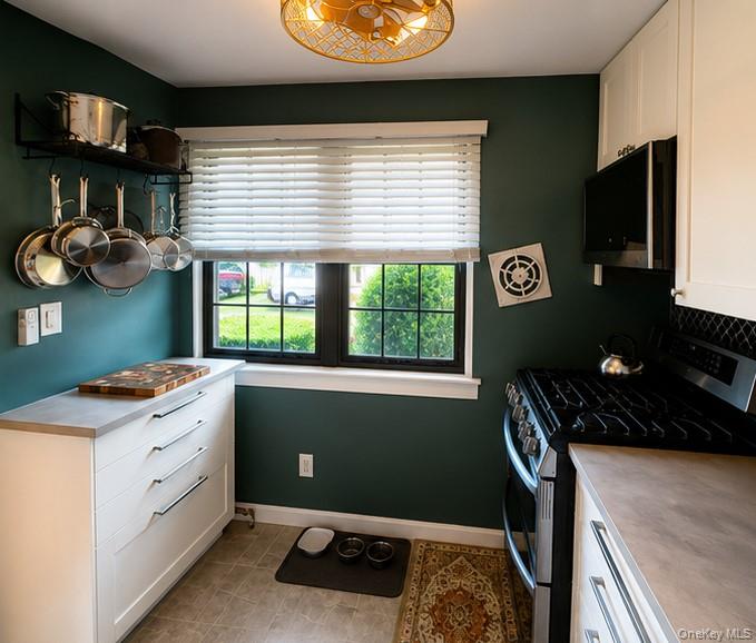 335 Mariners Way Copiague, NY 11726 - Photo 4 of 12 a kitchen with a refrigerator and a stove