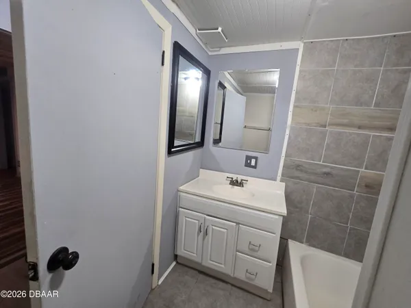 a bathroom with a sink toilet and mirror