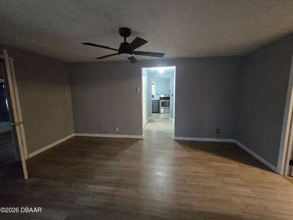 a view of an empty room and wooden floor