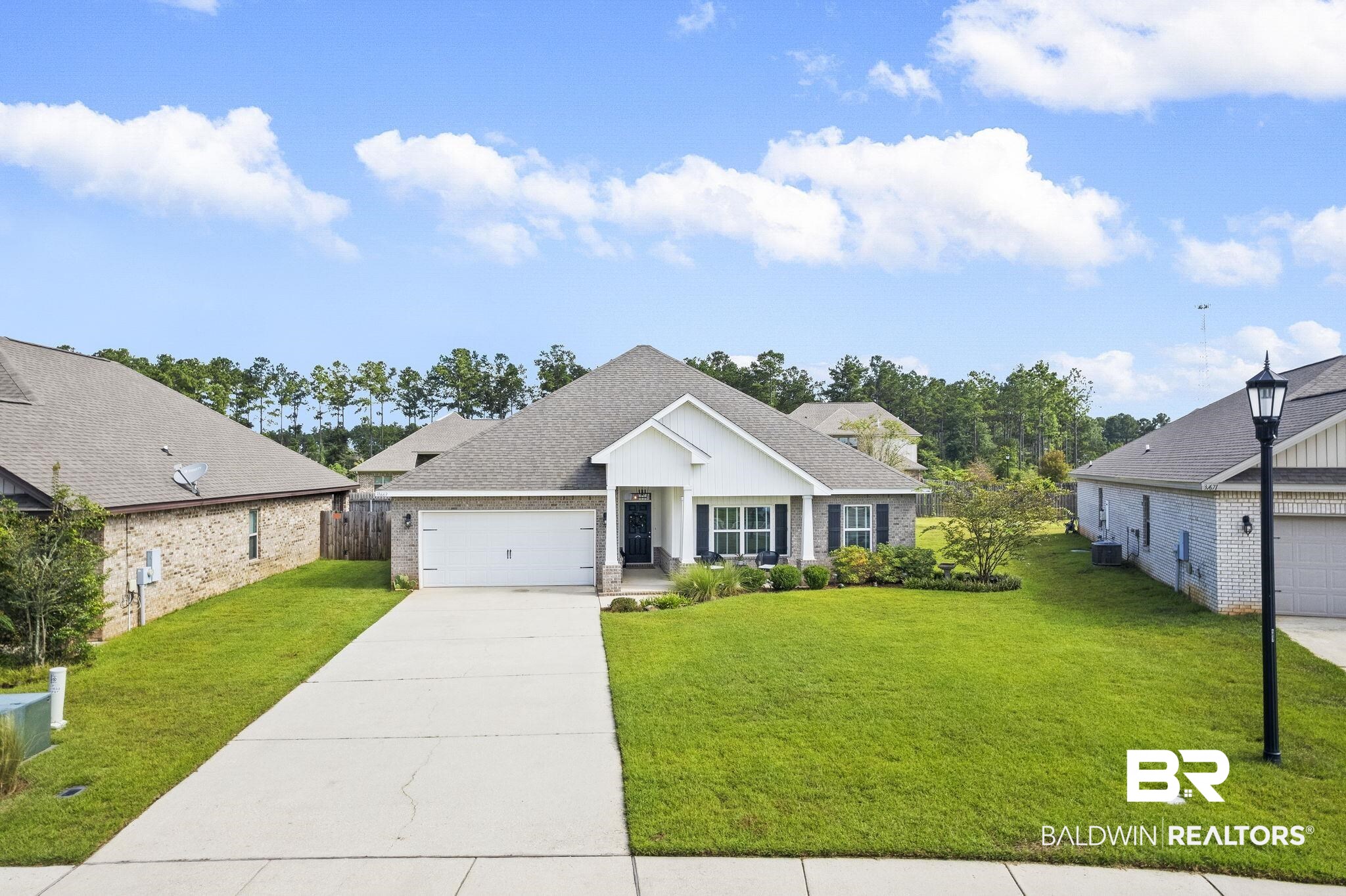 31663 Kestrel Loop Daphne, AL 36527 - Photo 62 of 86 View of front facade featuring a front yard, central AC unit, and a garage