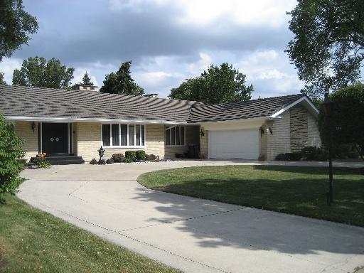 309 Uvedale Road Riverside, IL 60546 - Photo 1 of 15 a front view of a house with a yard and outdoor seating