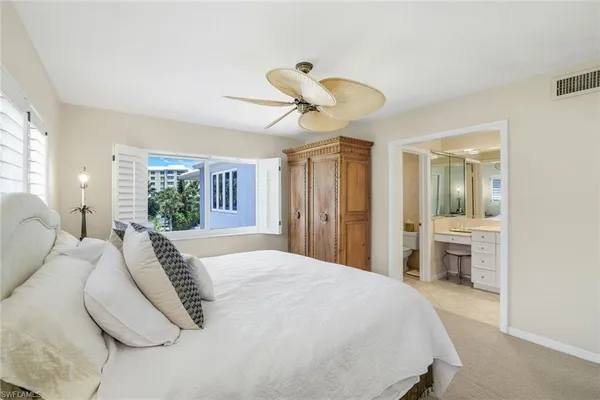a bathroom with a double vanity sink toilet mirror and bathtub