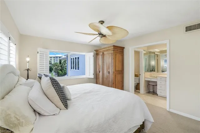 a bathroom with a double vanity sink toilet mirror and bathtub