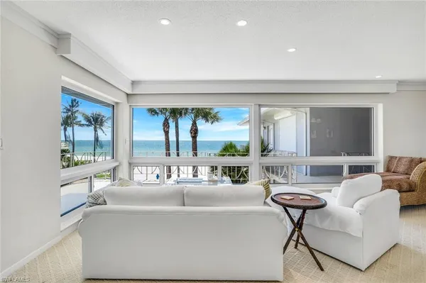 a living room with furniture a rug and a chandelier