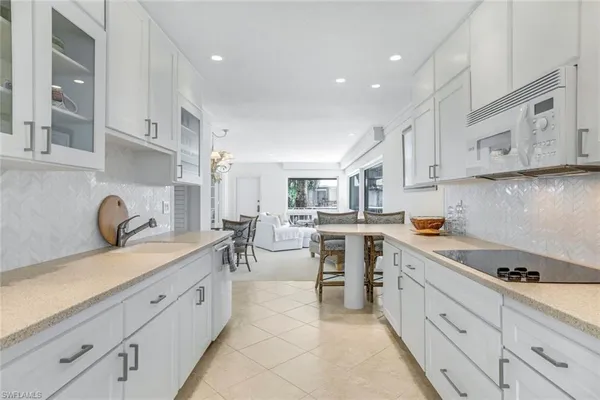 a kitchen with a sink cabinets and window