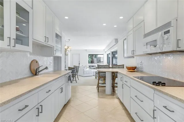 a kitchen with a sink cabinets and window