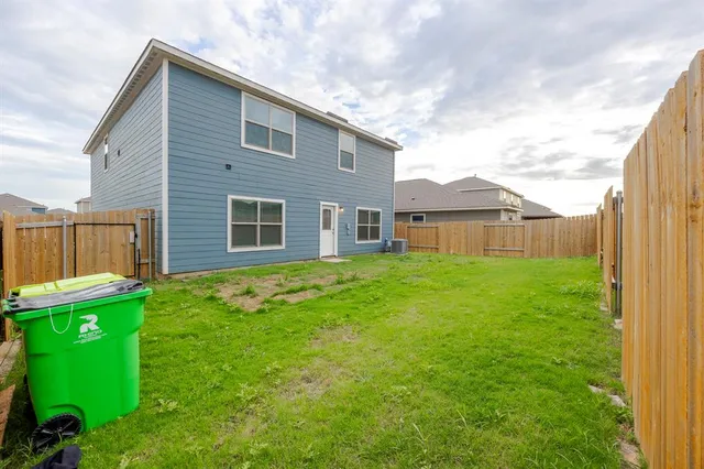 a view of a house with a yard and a garden