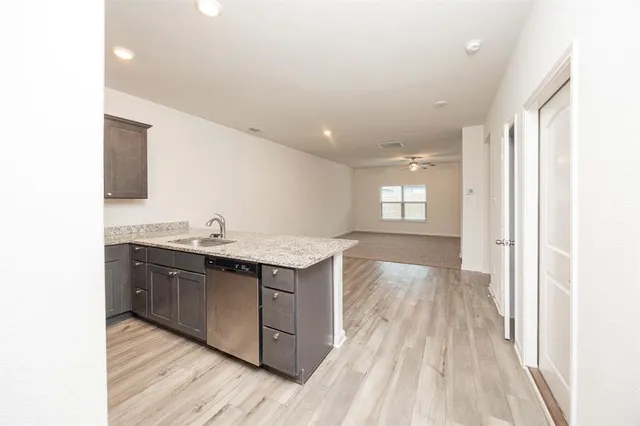 a kitchen with stainless steel appliances granite countertop a sink and cabinets