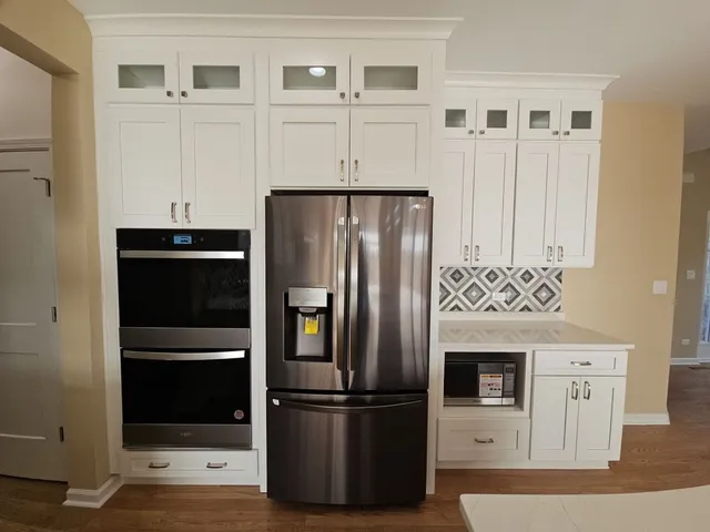 a kitchen with stainless steel appliances granite countertop a refrigerator and a stove