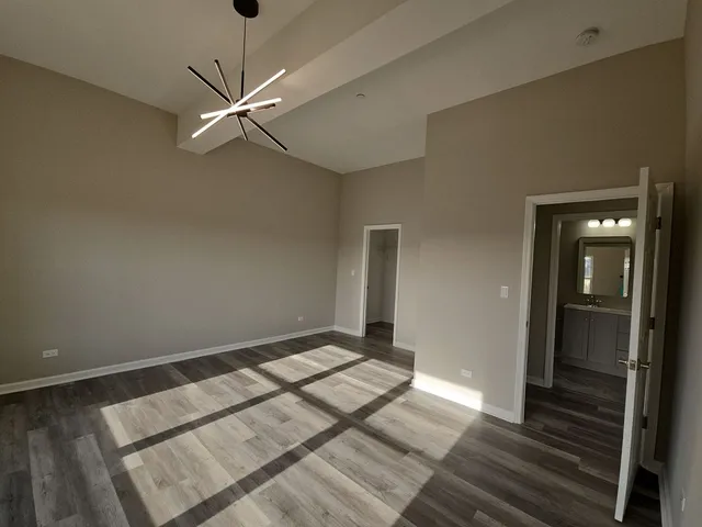 a view of an empty room and wooden floor