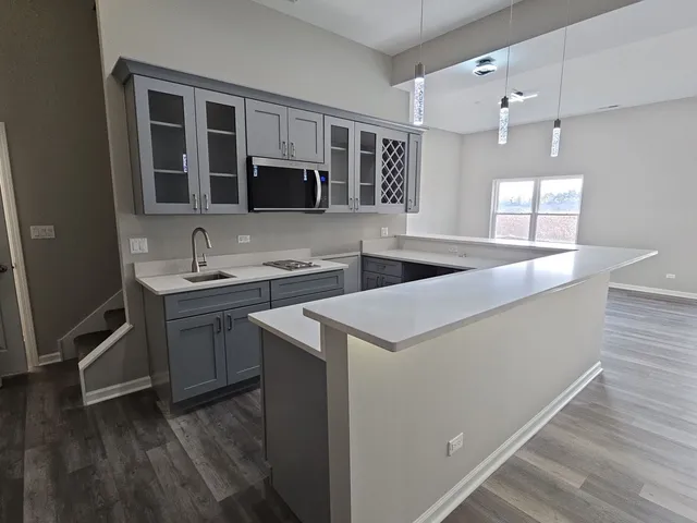 a kitchen that has a sink and a stove in it