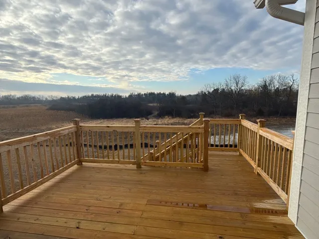 a view of a balcony with wooden chairs with wooden floor
