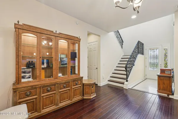 a hallway with wooden floors and cabinet