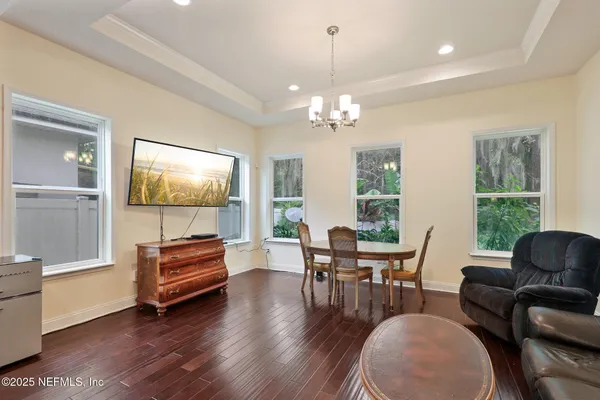 a view of a dining room with furniture wooden floor and chandelier