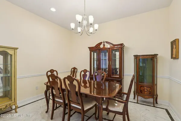 a view of a dining room with furniture and chandelier