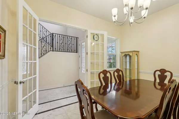 a view of a dining room with furniture and chandelier