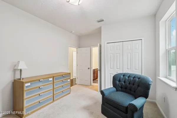 a en suite bathroom with a granite countertop sink and a mirror