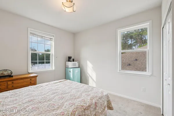 a large bedroom with bed and bathroom
