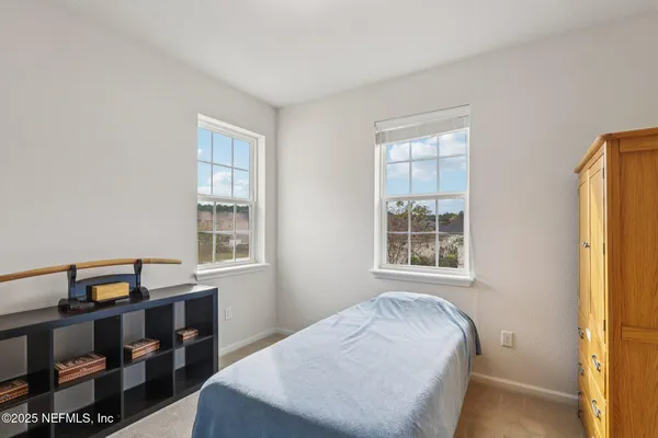 a bedroom with a bed and a cabinet
