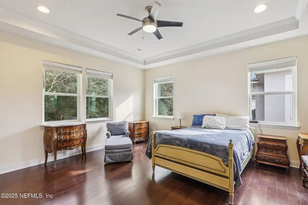 a bedroom with a bed chair and a window