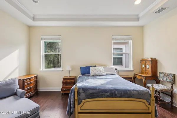 a bedroom with a bed and a couch