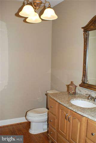 4444 Teen Barnes Road Jefferson, MD 21755 - Photo 13 of 30 a bathroom with a granite countertop toilet and a sink