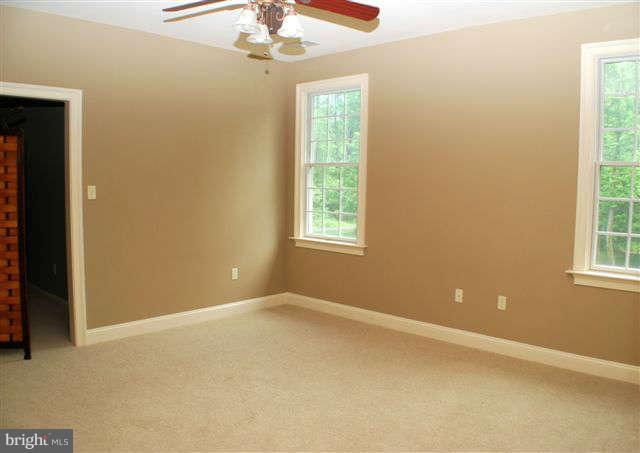 4444 Teen Barnes Road Jefferson, MD 21755 - Photo 20 of 30 an empty room with windows and chandelier fan