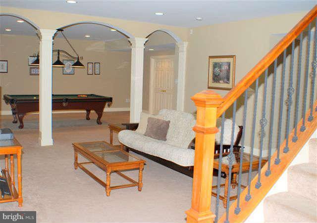 4444 Teen Barnes Road Jefferson, MD 21755 - Photo 24 of 30 a living room with couches and potted plants with wooden floor