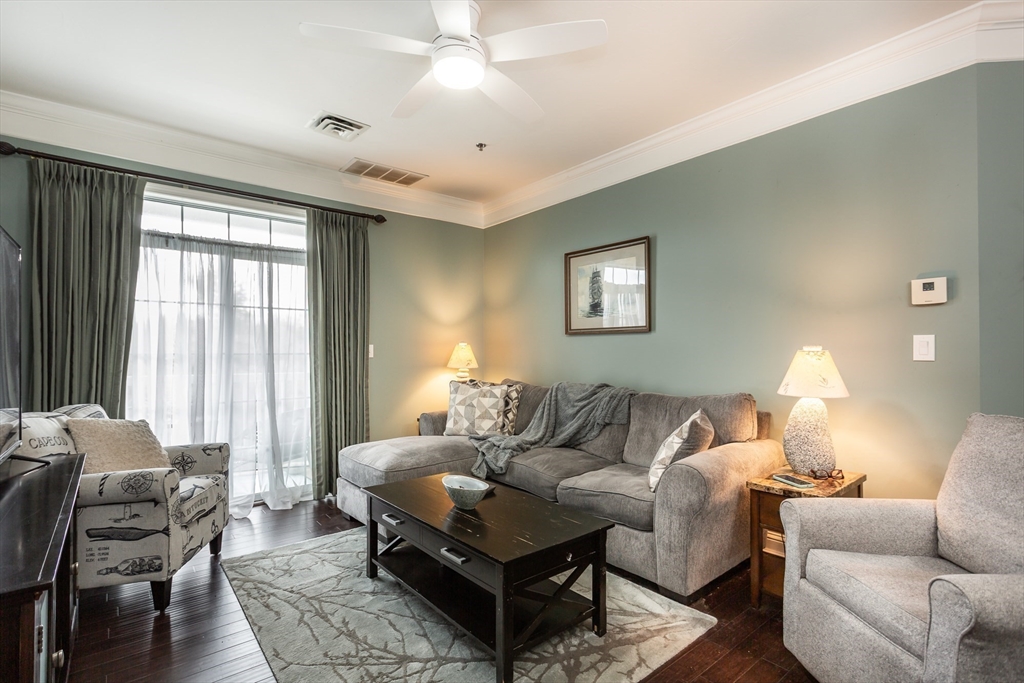 1481 Phillips Road, Unit 1305 New Bedford, MA 02745 - Photo 11 of 34 a living room with furniture and a large window