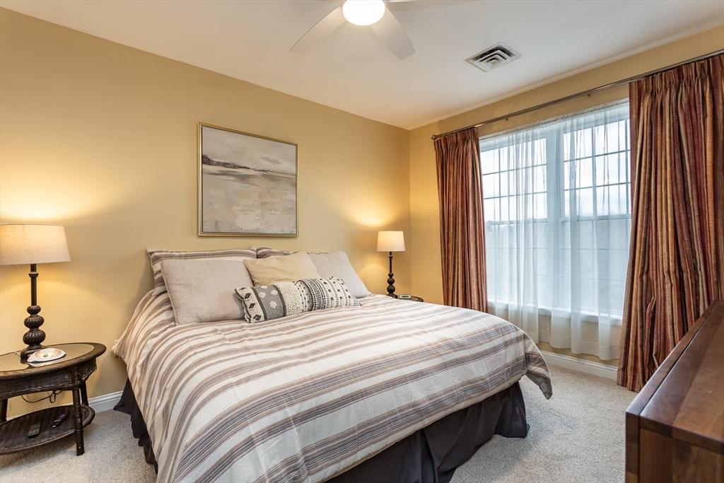 1481 Phillips Road, Unit 1305 New Bedford, MA 02745 - Photo 12 of 34 a bedroom with a bed and a lamp with window