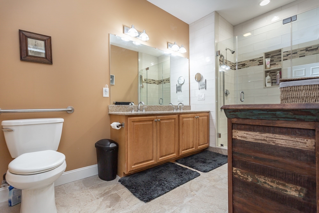 1481 Phillips Road, Unit 1305 New Bedford, MA 02745 - Photo 14 of 34 a bathroom with a toilet a sink and mirror