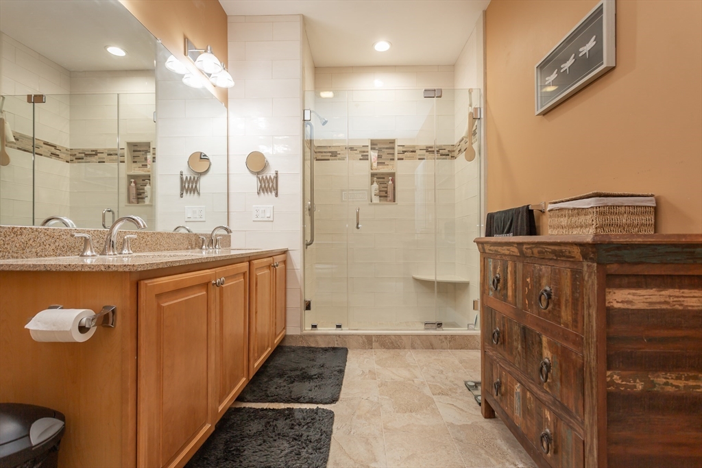 1481 Phillips Road, Unit 1305 New Bedford, MA 02745 - Photo 15 of 34 a bathroom with a granite countertop sink a mirror a vanity and shower