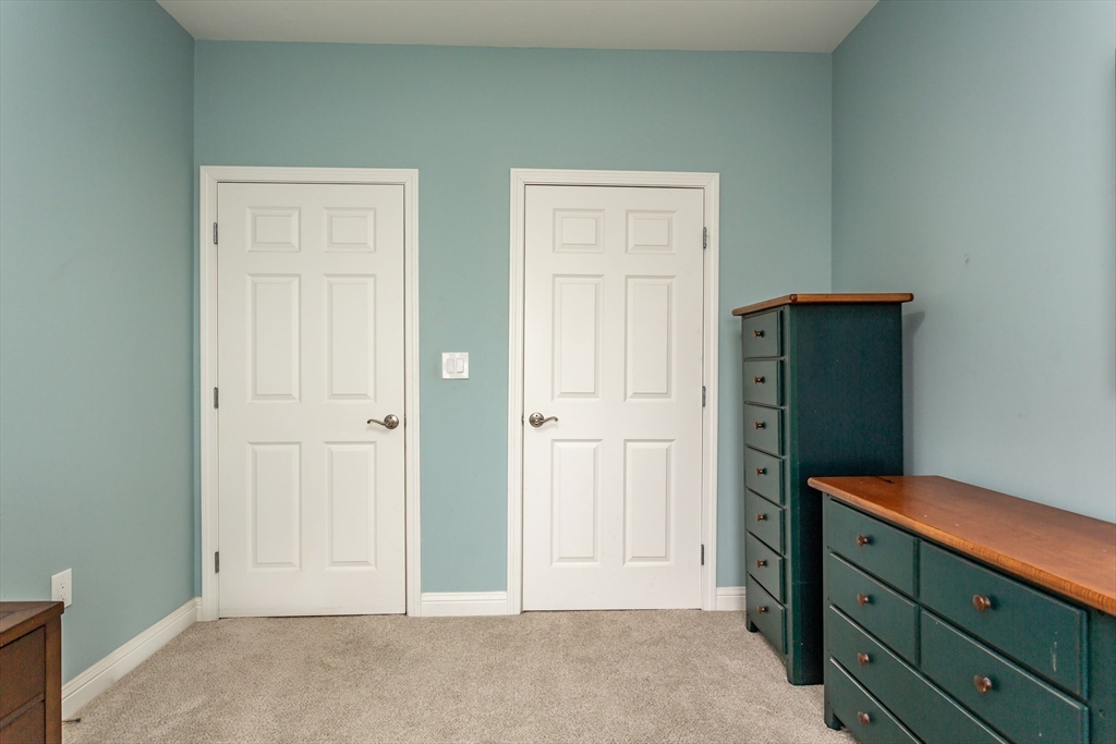 1481 Phillips Road, Unit 1305 New Bedford, MA 02745 - Photo 21 of 34 an empty room with mirror and door