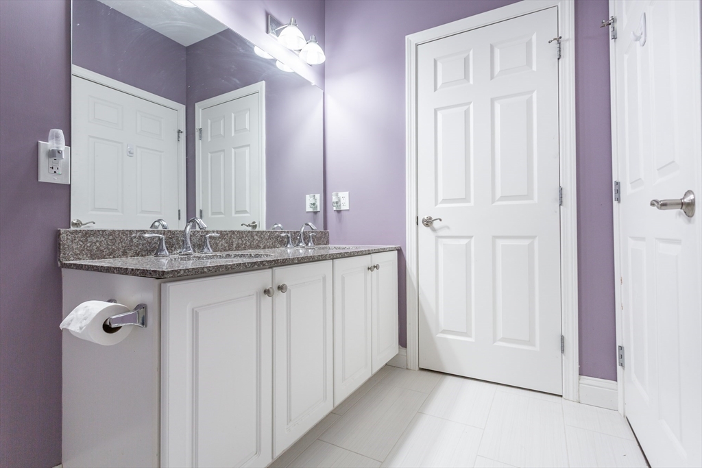 1481 Phillips Road, Unit 1305 New Bedford, MA 02745 - Photo 23 of 34 a bathroom with a granite countertop sink and a mirror