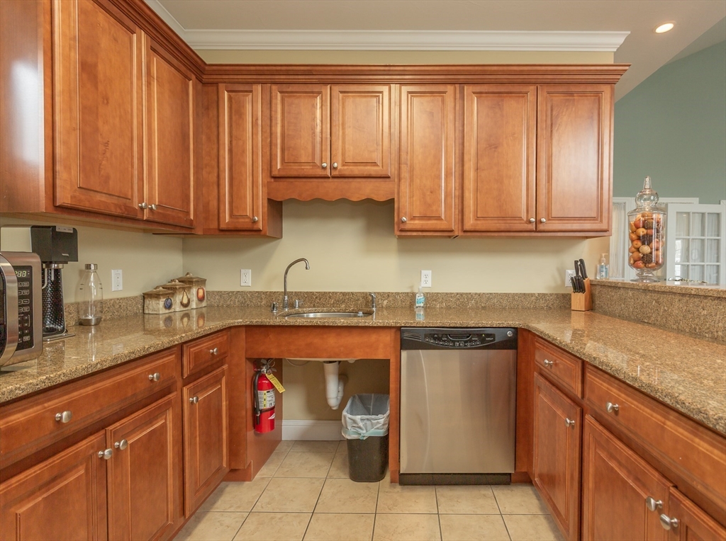1481 Phillips Road, Unit 1305 New Bedford, MA 02745 - Photo 31 of 34 a kitchen with stainless steel appliances granite countertop a sink stove and cabinets