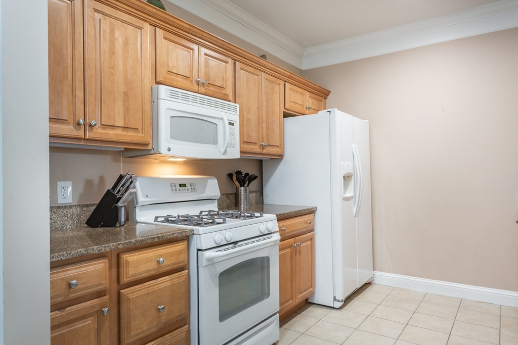 1481 Phillips Road, Unit 1305 New Bedford, MA 02745 - Photo 5 of 34 a kitchen with granite countertop cabinets and appliances