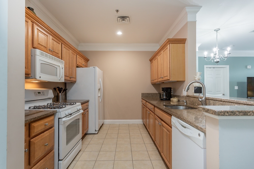 1481 Phillips Road, Unit 1305 New Bedford, MA 02745 - Photo 6 of 34 a kitchen with a sink stove and cabinets