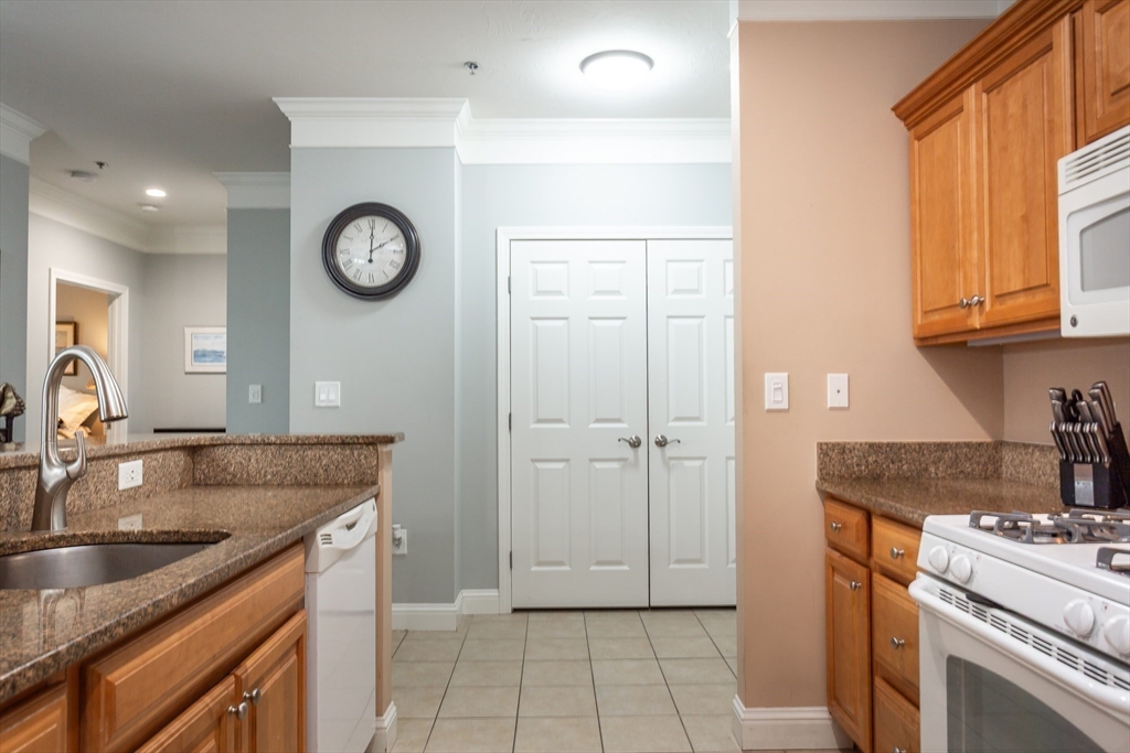1481 Phillips Road, Unit 1305 New Bedford, MA 02745 - Photo 8 of 34 a kitchen with a sink and a stove top oven with a dishwasher